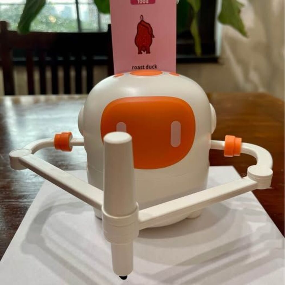 White orange drawing robot
